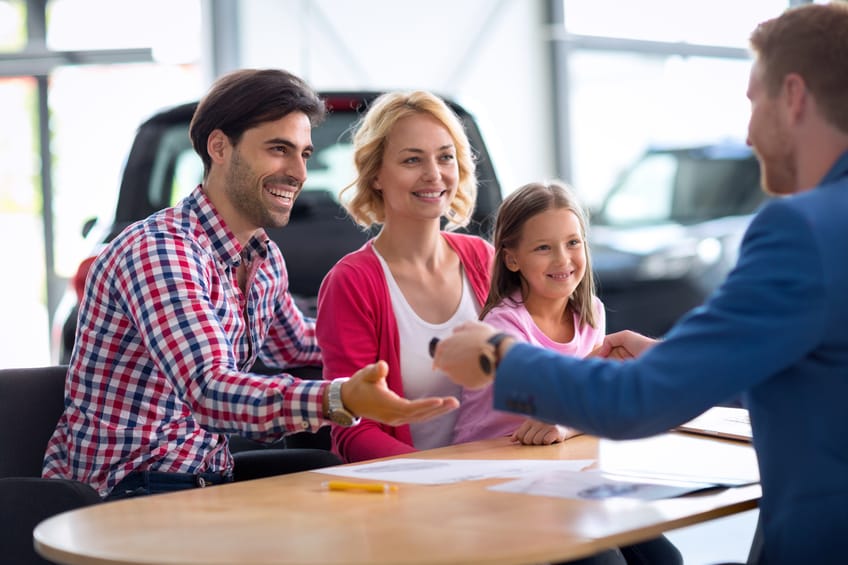 Family purchasing car from dealer